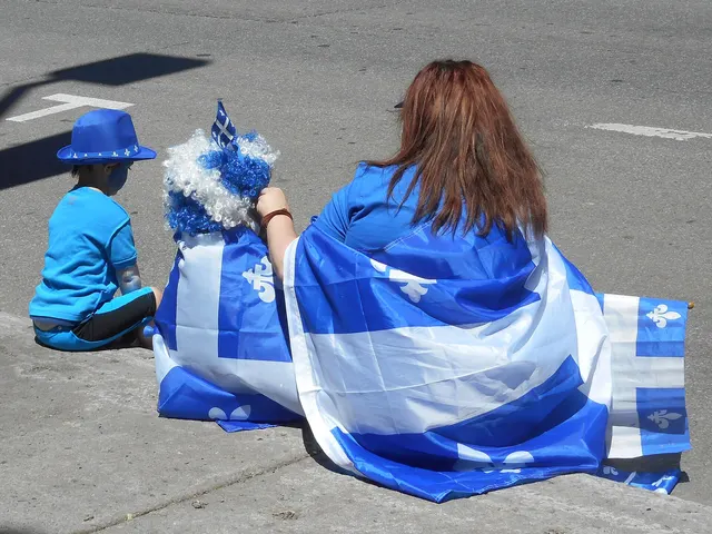 Spectators wrapped in Quebec flags at a Fête nationale parade