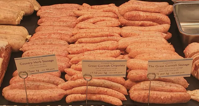 House-made sausages lined up in a butcher's counter