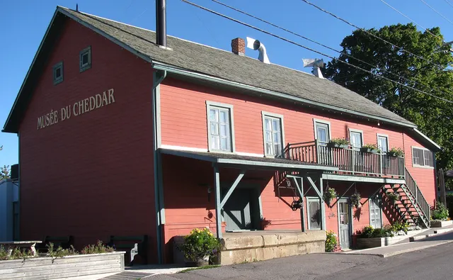 The old Perron cheese factory, a red wooden building in Saint-Prime, Quebec