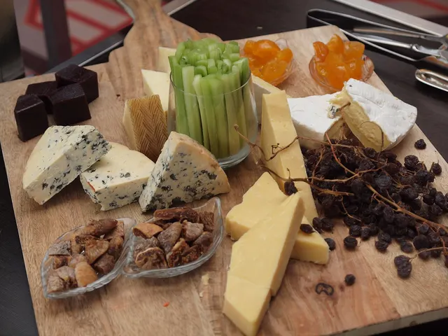 Board of assorted cheeses with dried fruit and celery