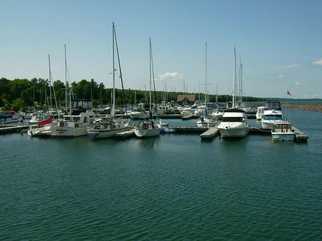 Sailboats and motorboats moored at the docks of a small Ontario marina