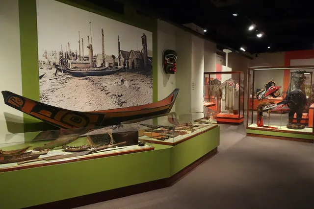 Museum gallery with an Indigenous canoe and historical objects