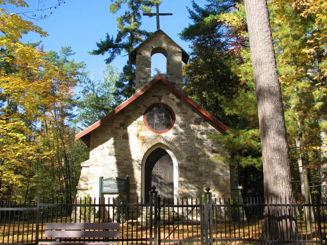 The small stone Papineau family funeral chapel among autumn trees