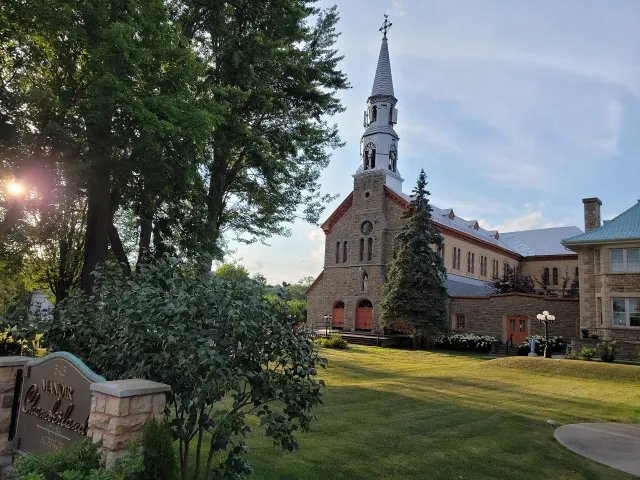 Montebello's brick church seen at an angle between trees
