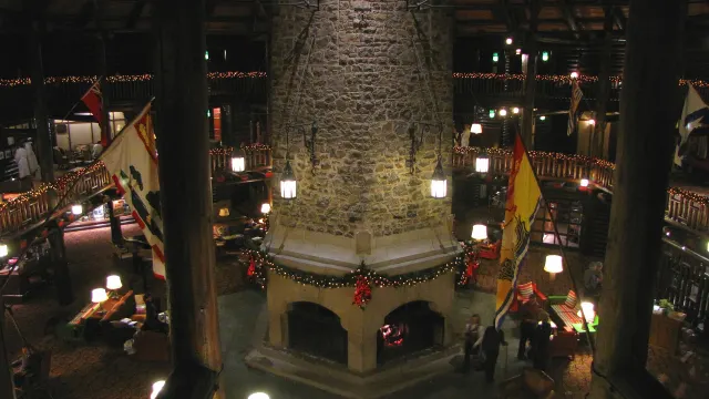The large hexagonal stone fireplace in the Château Montebello lobby, decorated for the holidays
