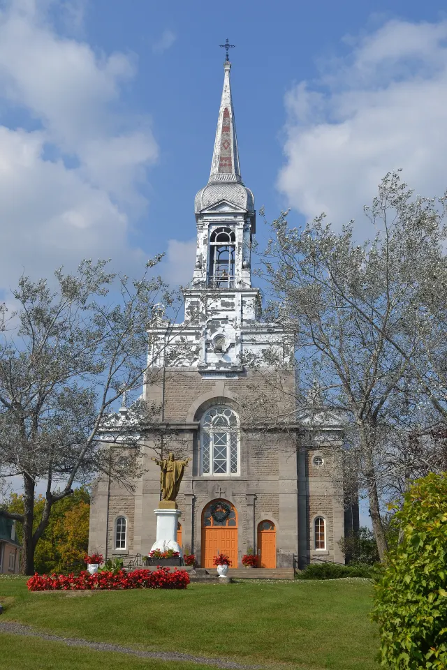 Sainte-Angélique church in Papineauville, stone façade and tall steeple