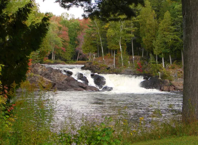 A small falls on the Petite Nation River in Ripon, trees in fall colours