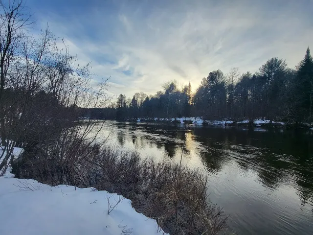 The Petite Nation River at sunset, banks still snowy in March