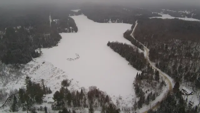 Aerial view of frozen Lac Hacquard and the road along its shore